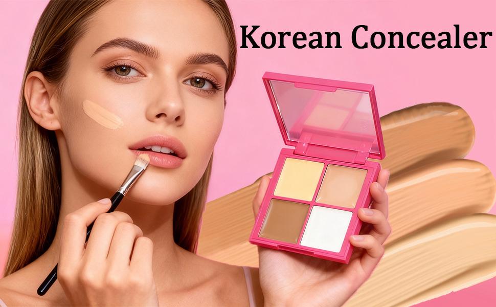 Woman applying concealer with a brush and a pink concealer palette on a pink background